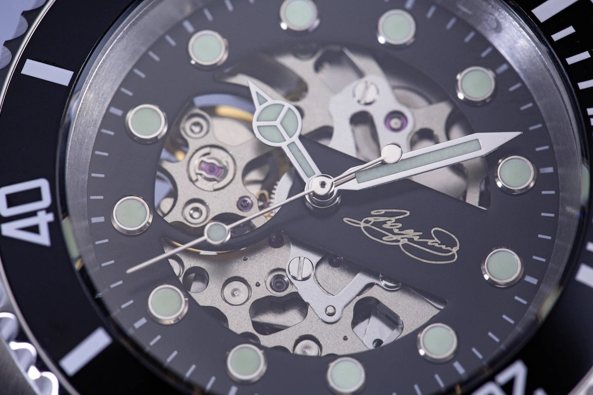 handwritten signature on watch dial